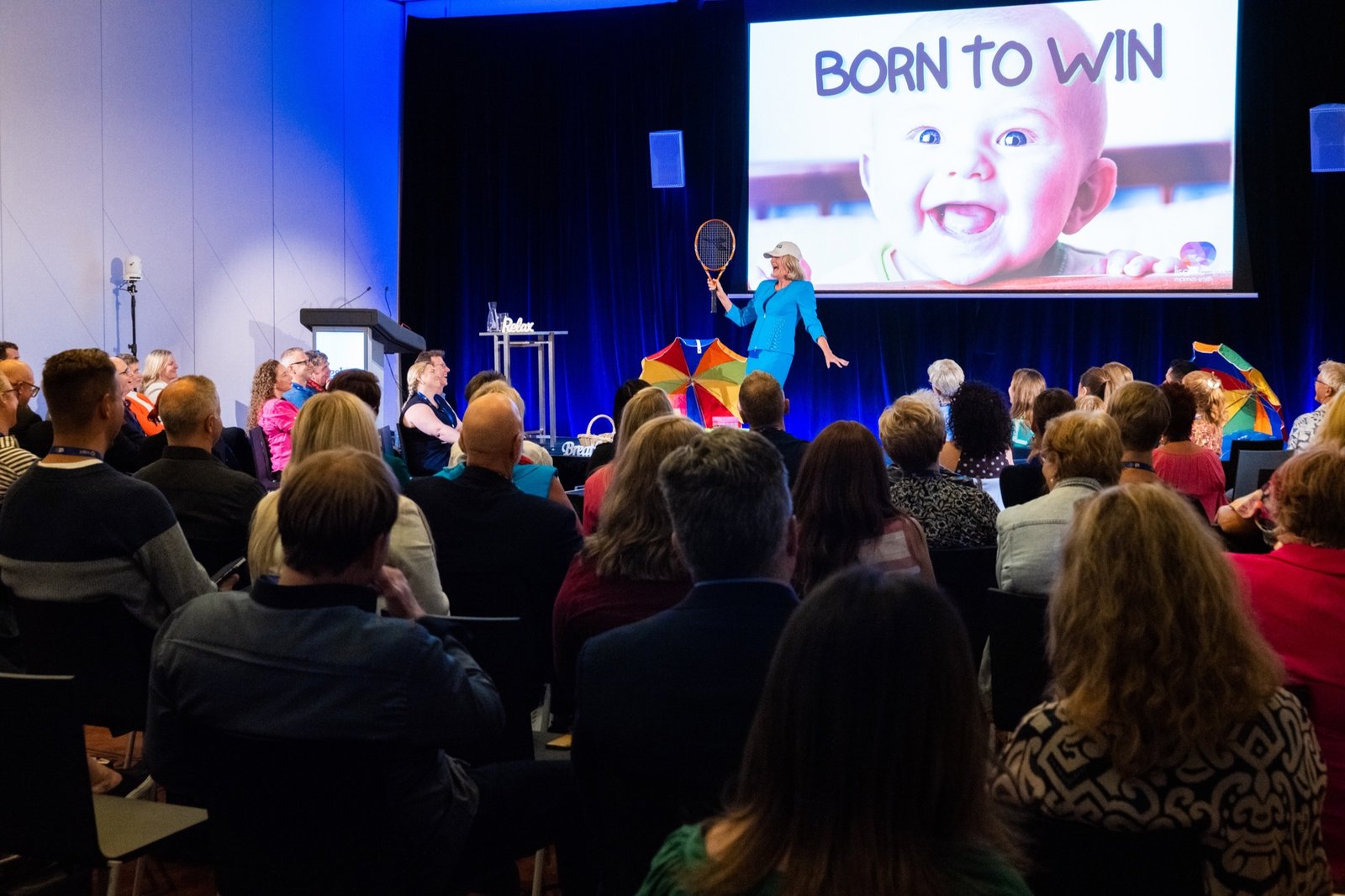 Lisa presenting Born to Win to a live audience